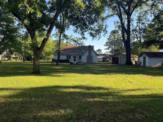 1006 W Main, Ridge Spring, SC 29129 - view of green lawn with a garage and an outdoor structure