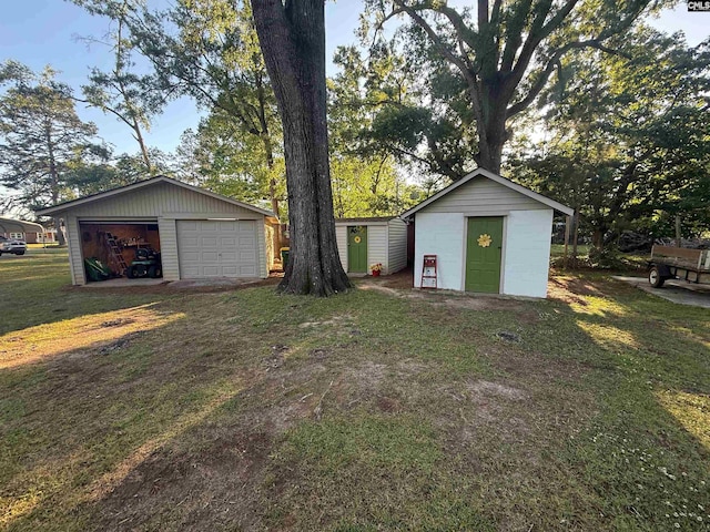 1006 W Main, Ridge Spring, SC 29129 - view of green lawn featuring an outdoor structure, a garage, and a storage unit
