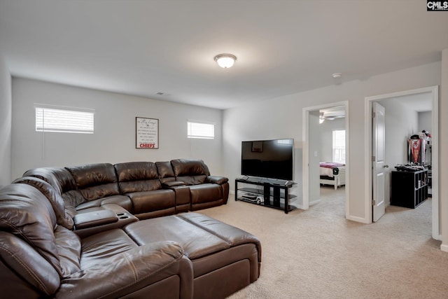 living area featuring light colored carpet and baseboards