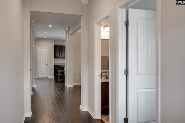 hall featuring baseboards, dark wood-style floors, and recessed lighting