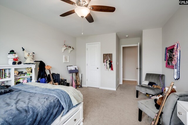 bedroom featuring light carpet, a ceiling fan, and baseboards