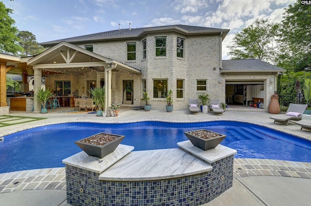 outdoor pool featuring a patio area, a ceiling fan, and area for grilling