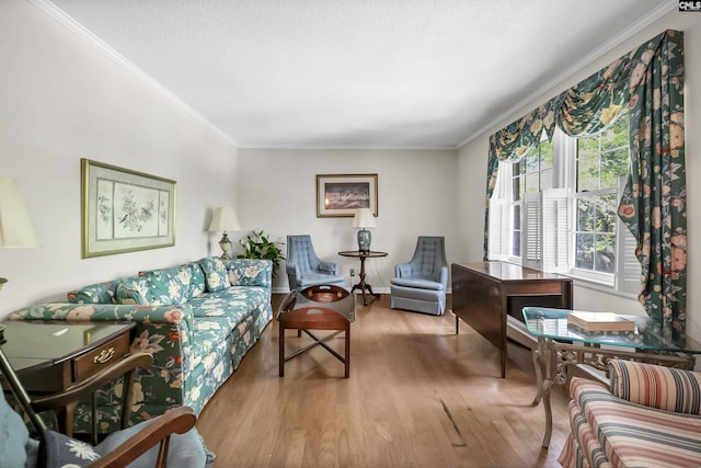 living area with ornamental molding, wood finished floors, and a textured ceiling