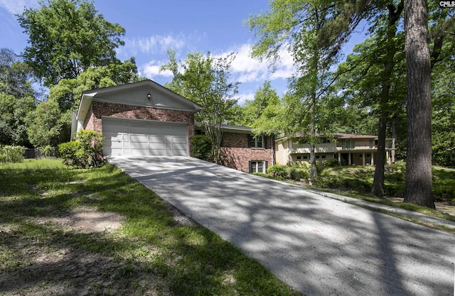 single story home featuring brick siding, concrete driveway, and an attached garage