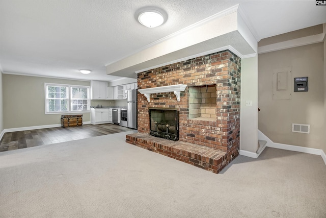 unfurnished living room featuring dark colored carpet, baseboards, a fireplace, ornamental molding, and stairs