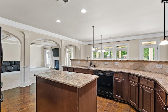 kitchen with black dishwasher, a sink, arched walkways, a center island, and ornamental molding