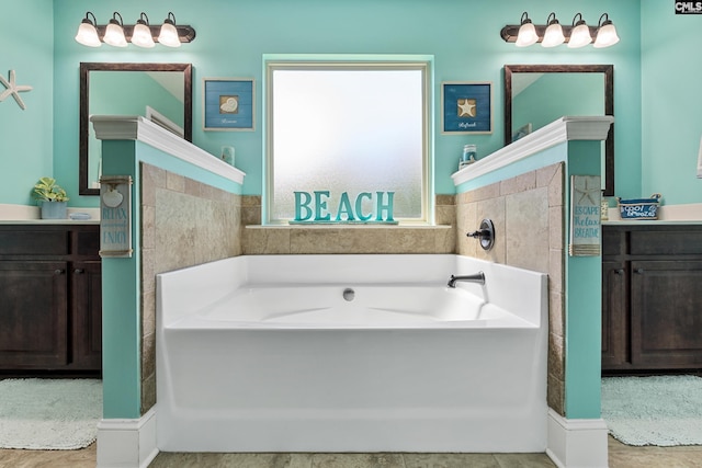 full bath featuring vanity and a garden tub