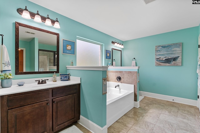 bathroom featuring a garden tub, baseboards, and vanity
