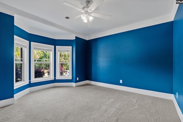carpeted spare room featuring baseboards, crown molding, and ceiling fan