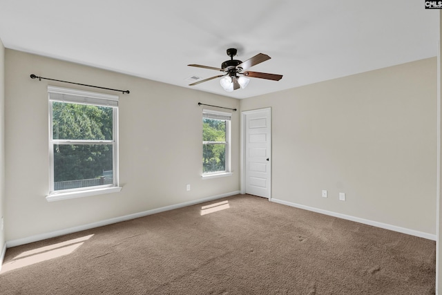 spare room with baseboards, carpet, and ceiling fan