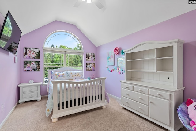 bedroom with vaulted ceiling, light colored carpet, ceiling fan, and baseboards