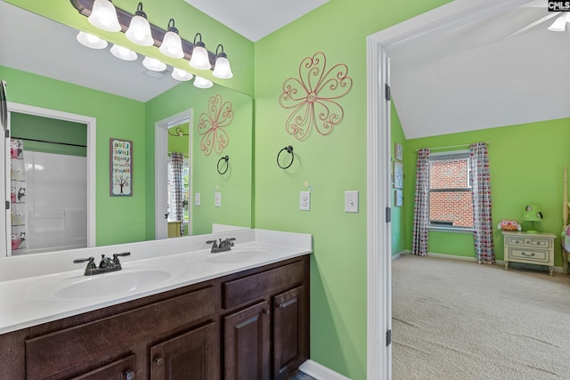 bathroom with double vanity and baseboards