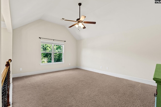 spare room featuring carpet flooring, a ceiling fan, lofted ceiling, and baseboards