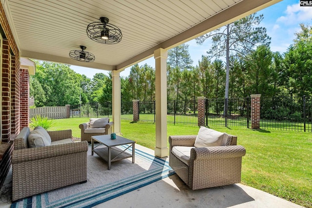 view of patio / terrace featuring outdoor lounge area and view of wooded area