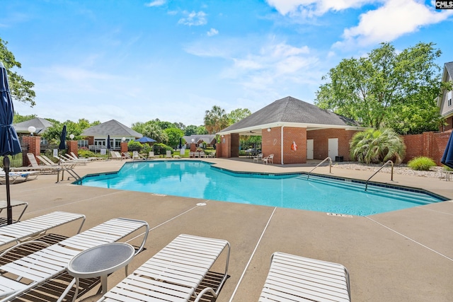 community pool featuring a patio area and fence