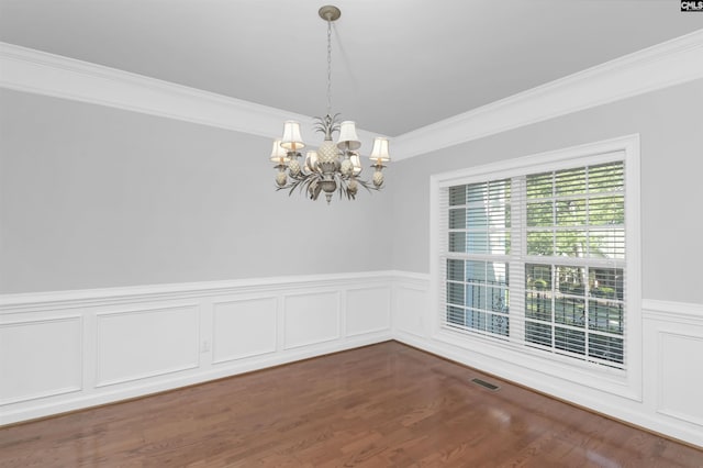 5 Stonewall Ct, Irmo, SC 29063 - unfurnished dining area featuring a chandelier, crown molding, wainscoting, wood finished floors, and a decorative wall