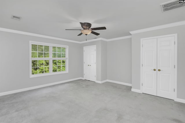 5 Stonewall Ct, Irmo, SC 29063 - unfurnished bedroom with two closets, baseboards, crown molding, carpet flooring, and ceiling fan