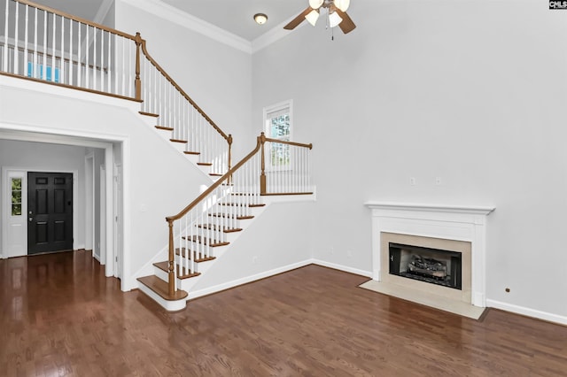 5 Stonewall Ct, Irmo, SC 29063 - unfurnished living room featuring a ceiling fan, stairs, wood finished floors, a high ceiling, and healthy amount of natural light