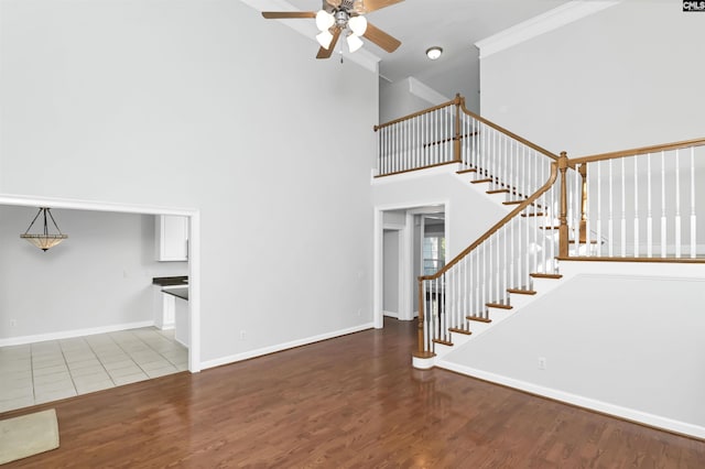 5 Stonewall Ct, Irmo, SC 29063 - stairs featuring a high ceiling, a ceiling fan, wood finished floors, and baseboards