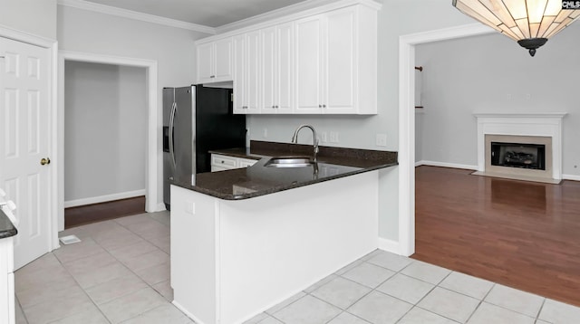 5 Stonewall Ct, Irmo, SC 29063 - kitchen featuring a sink, crown molding, white cabinetry, light tile patterned floors, and baseboards