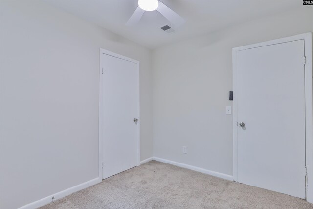 empty room with carpet floors, ceiling fan, and baseboards