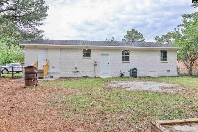 rear view of house featuring entry steps, brick siding, central AC unit, and crawl space