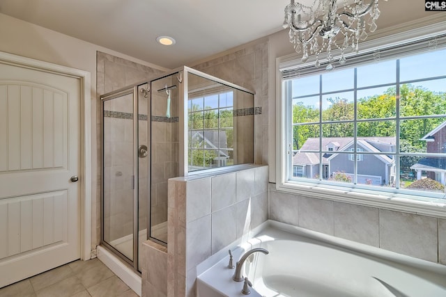 full bathroom with a stall shower, a chandelier, tile patterned floors, and a bath