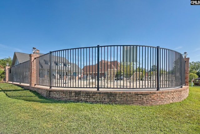gate featuring a lawn
