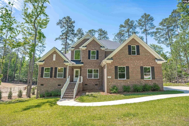 view of front of property featuring a front yard and brick siding