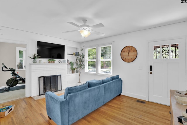 3803 Yale Ave, Columbia, SC 29205 - living area with light wood-style flooring, ceiling fan, healthy amount of natural light, and a fireplace