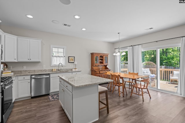 255 Honey Hill Way, Blythewood, SC 29016 - kitchen featuring dishwasher, a sink, gas range, dark wood finished floors, and white cabinetry