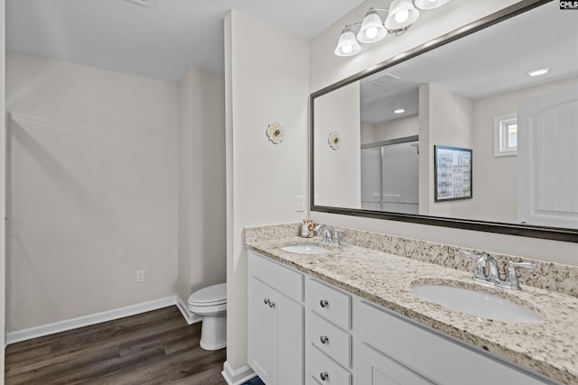 255 Honey Hill Way, Blythewood, SC 29016 - bathroom featuring toilet, wood finished floors, a stall shower, double vanity, and baseboards