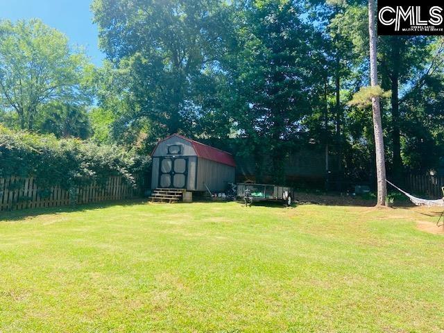 319 Mooring Ln, Lexington, SC 29072 - view of yard featuring an outbuilding, a storage unit, and view of wooded area