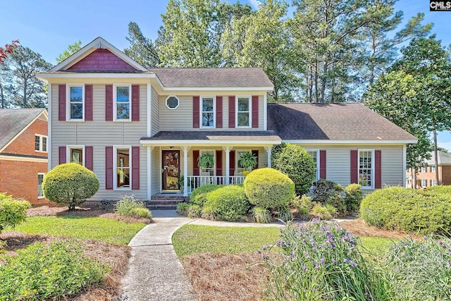 view of front of property with covered porch and roof with shingles