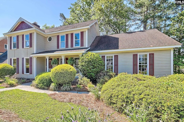 view of front of home with a shingled roof