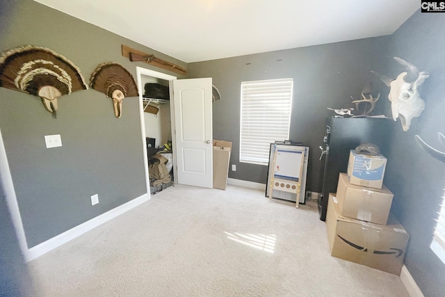 rec room with light colored carpet and baseboards
