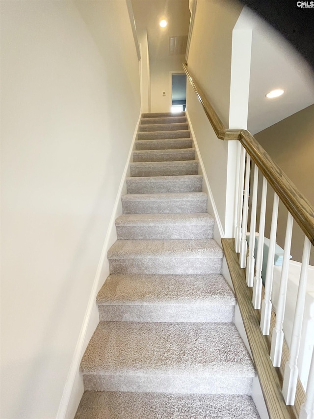stairs featuring carpet flooring and recessed lighting
