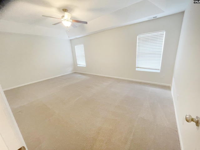 unfurnished room featuring light carpet, ceiling fan, and baseboards