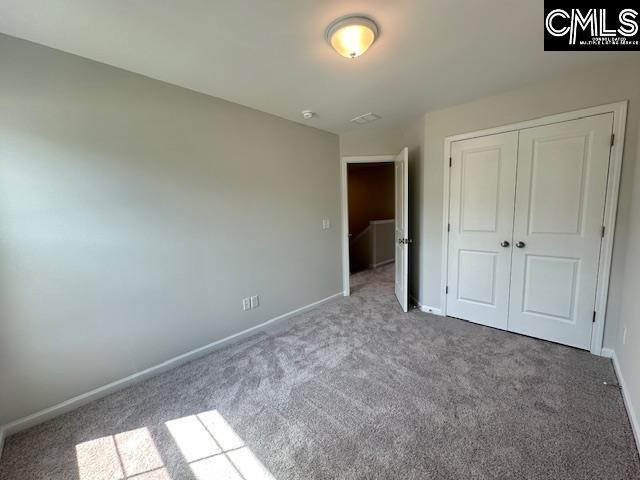 2040 Skyline Rd, Columbia, SC 29229 - unfurnished bedroom featuring carpet flooring, baseboards, and a closet