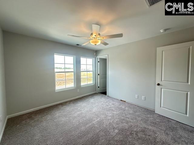 2040 Skyline Rd, Columbia, SC 29229 - unfurnished bedroom with carpet, baseboards, and a ceiling fan