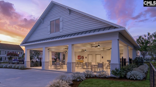 2040 Skyline Rd, Columbia, SC 29229 - back of house featuring brick siding, a ceiling fan, outdoor dining area, and a standing seam roof