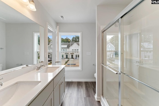 2040 Skyline Rd, Columbia, SC 29229 - full bath featuring toilet, double vanity, wood finished floors, a stall shower, and baseboards