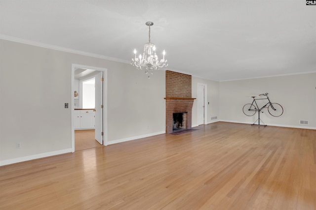 604 Shady Ln, Cayce, SC 29033 - unfurnished living room with a chandelier, light wood finished floors, baseboards, and ornamental molding