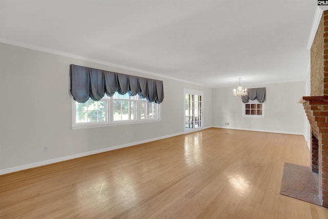 604 Shady Ln, Cayce, SC 29033 - unfurnished living room with a chandelier, a fireplace, healthy amount of natural light, light wood finished floors, and crown molding