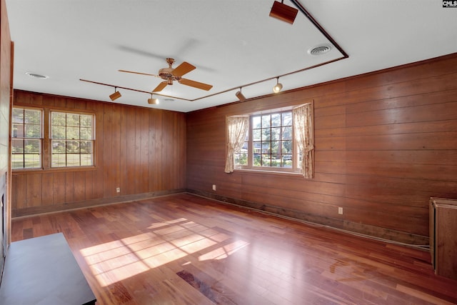 604 Shady Ln, Cayce, SC 29033 - spare room featuring healthy amount of natural light, wood finished floors, wooden walls, baseboards, and a ceiling fan