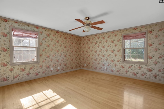 604 Shady Ln, Cayce, SC 29033 - spare room featuring wood finished floors, ornamental molding, ceiling fan, and baseboards