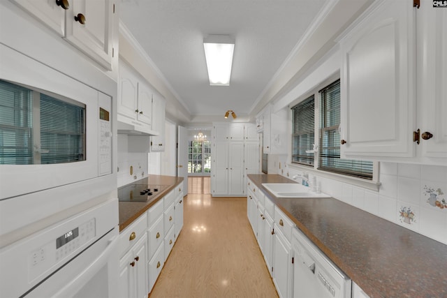 604 Shady Ln, Cayce, SC 29033 - kitchen with white appliances, a sink, decorative backsplash, ornamental molding, and dark countertops