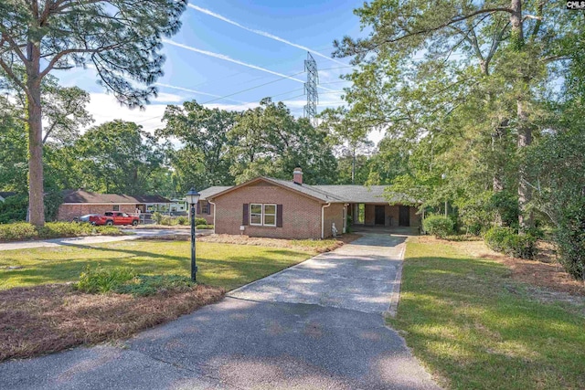 604 Shady Ln, Cayce, SC 29033 - ranch-style house featuring driveway, a chimney, a front lawn, brick siding, and an attached carport