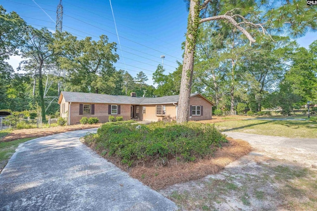 604 Shady Ln, Cayce, SC 29033 - single story home with driveway, fence, view of wooded area, and brick siding