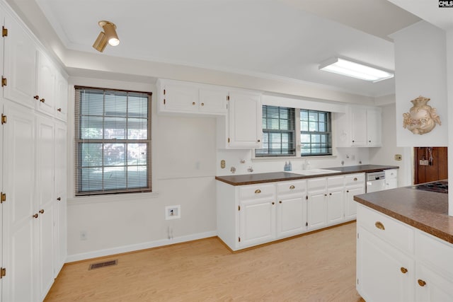 604 Shady Ln, Cayce, SC 29033 - kitchen with dark countertops, light wood-style flooring, white cabinets, black electric stovetop, and ornamental molding